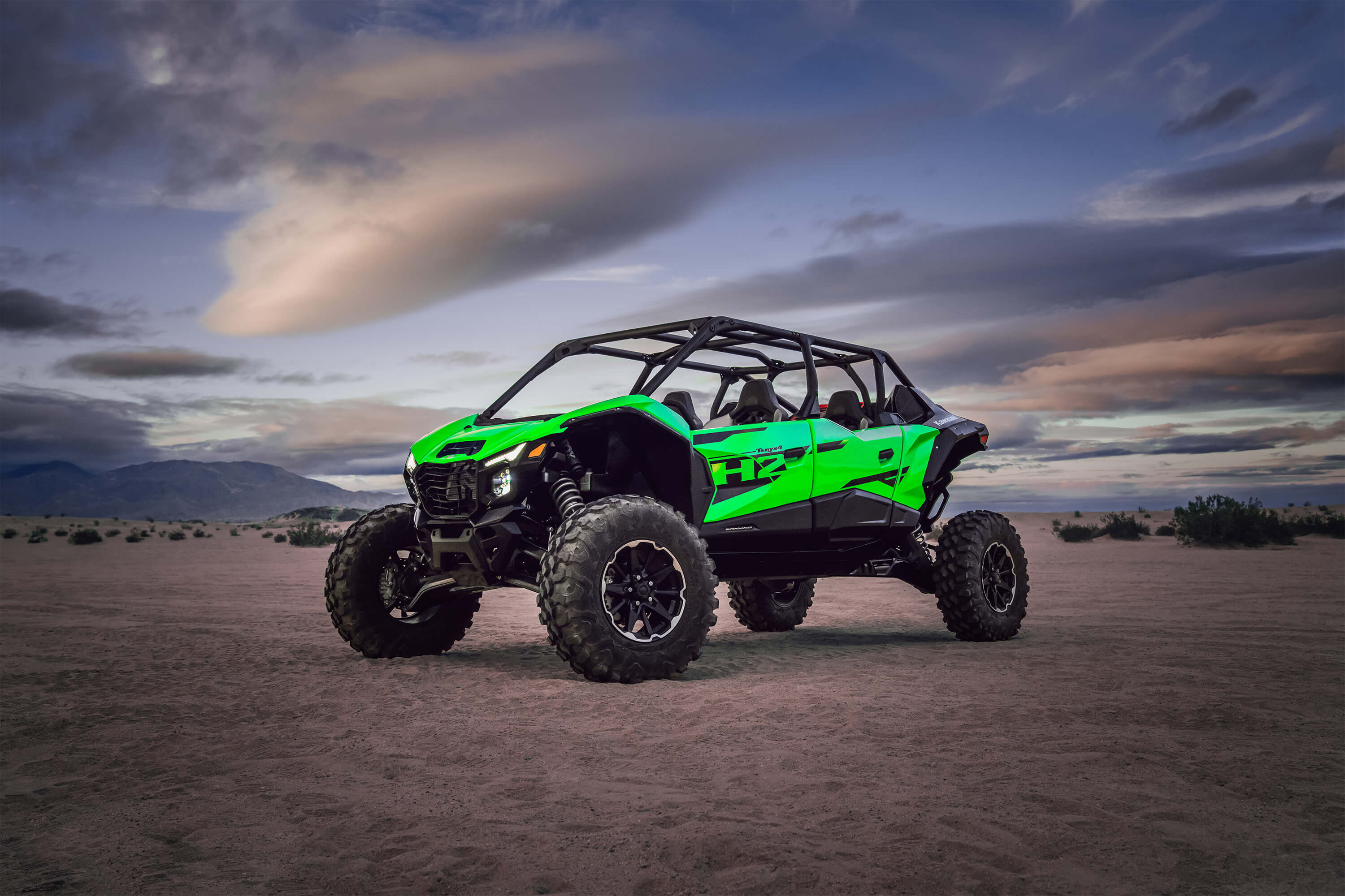 2026 Kawasaki Teryx4 H2 parked in the desert at dusk with off-road tires and bold green styling.